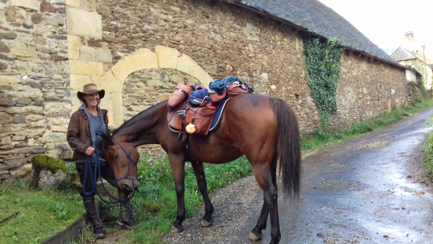 馬で巡礼路を歩いている女性。ガイドブックに馬もOKという宿があります。
